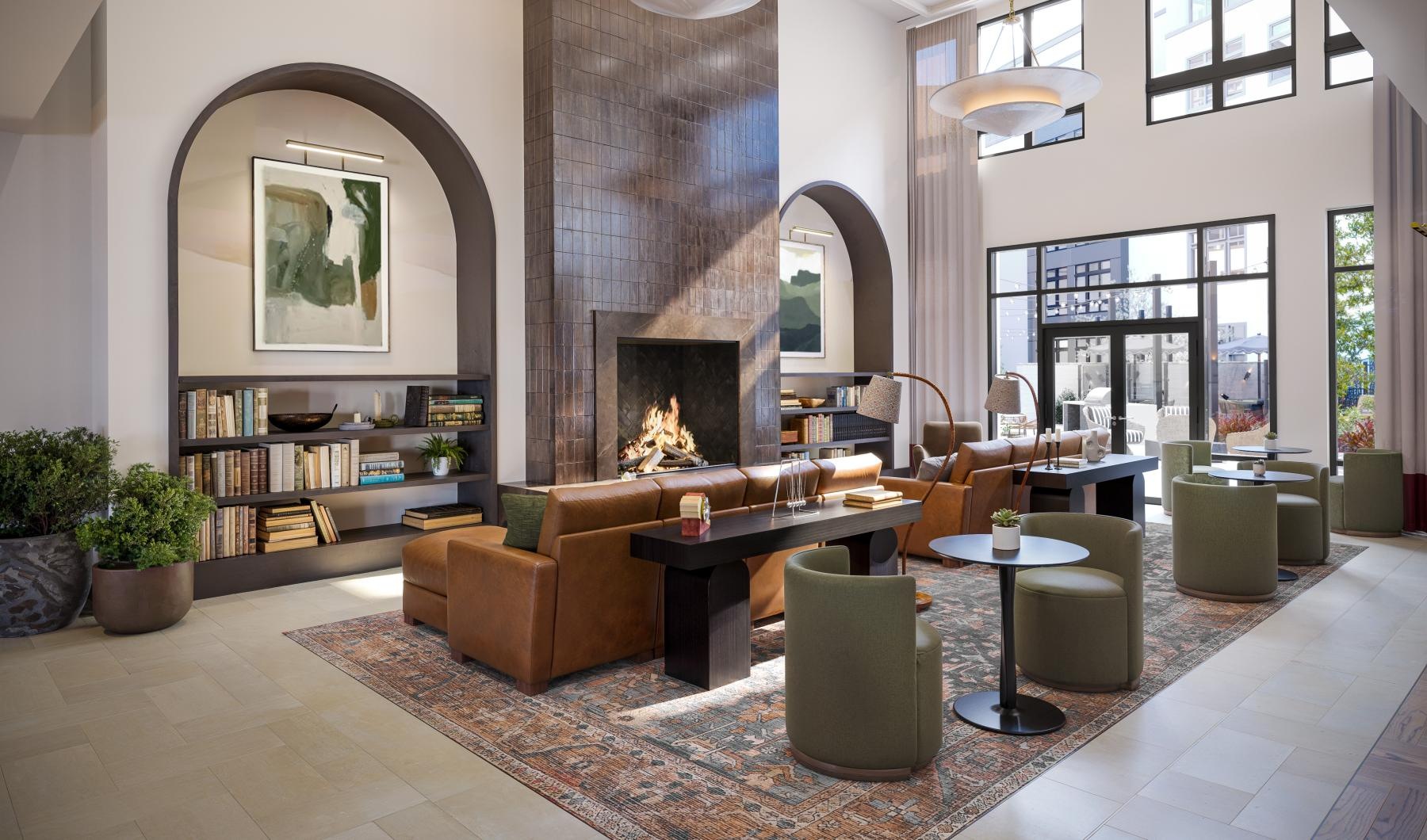 a lounge with couches, chairs and a fireplace