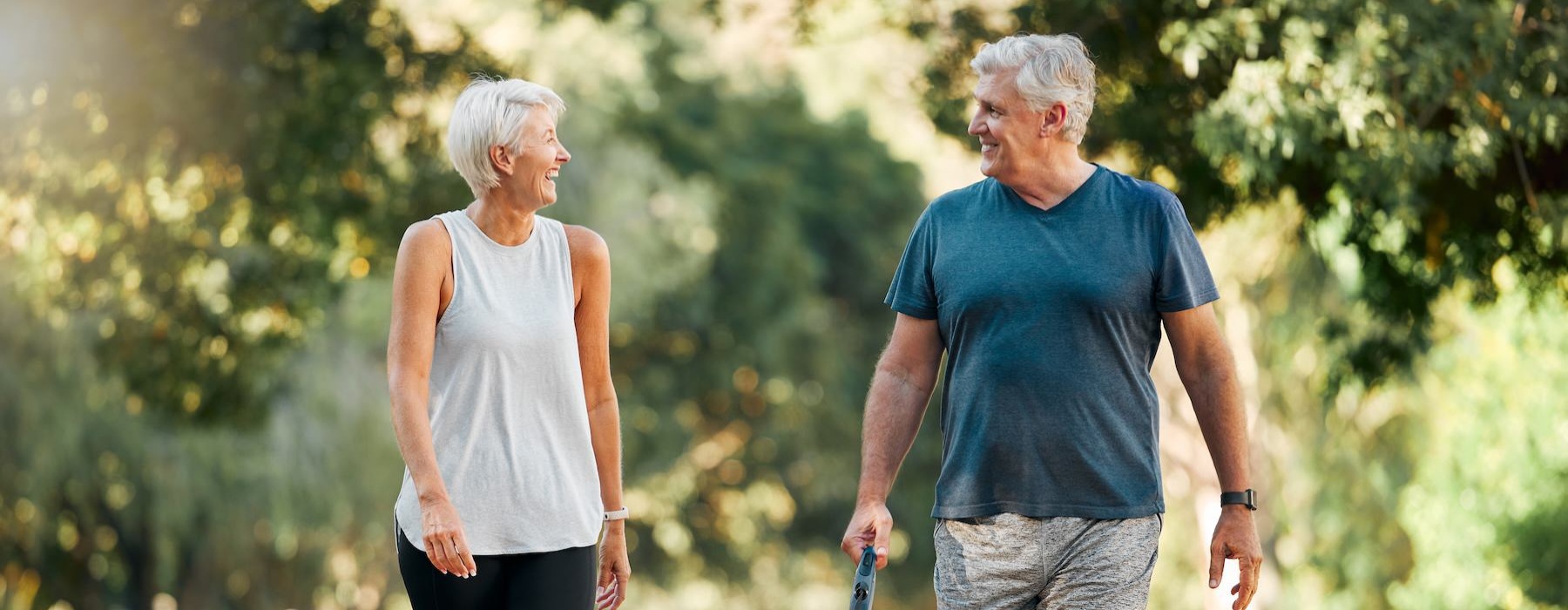 a man and woman walking a dog