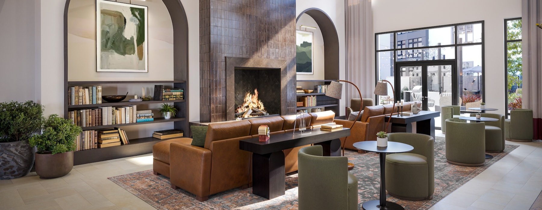 a lounge with couches, chairs and a fireplace